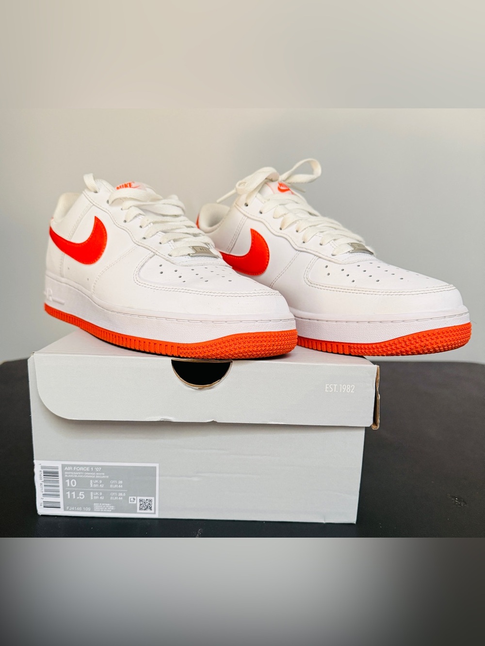 Nike Air Force 1 ‘07
White Sneakers with Vibrant Orange Swoosh